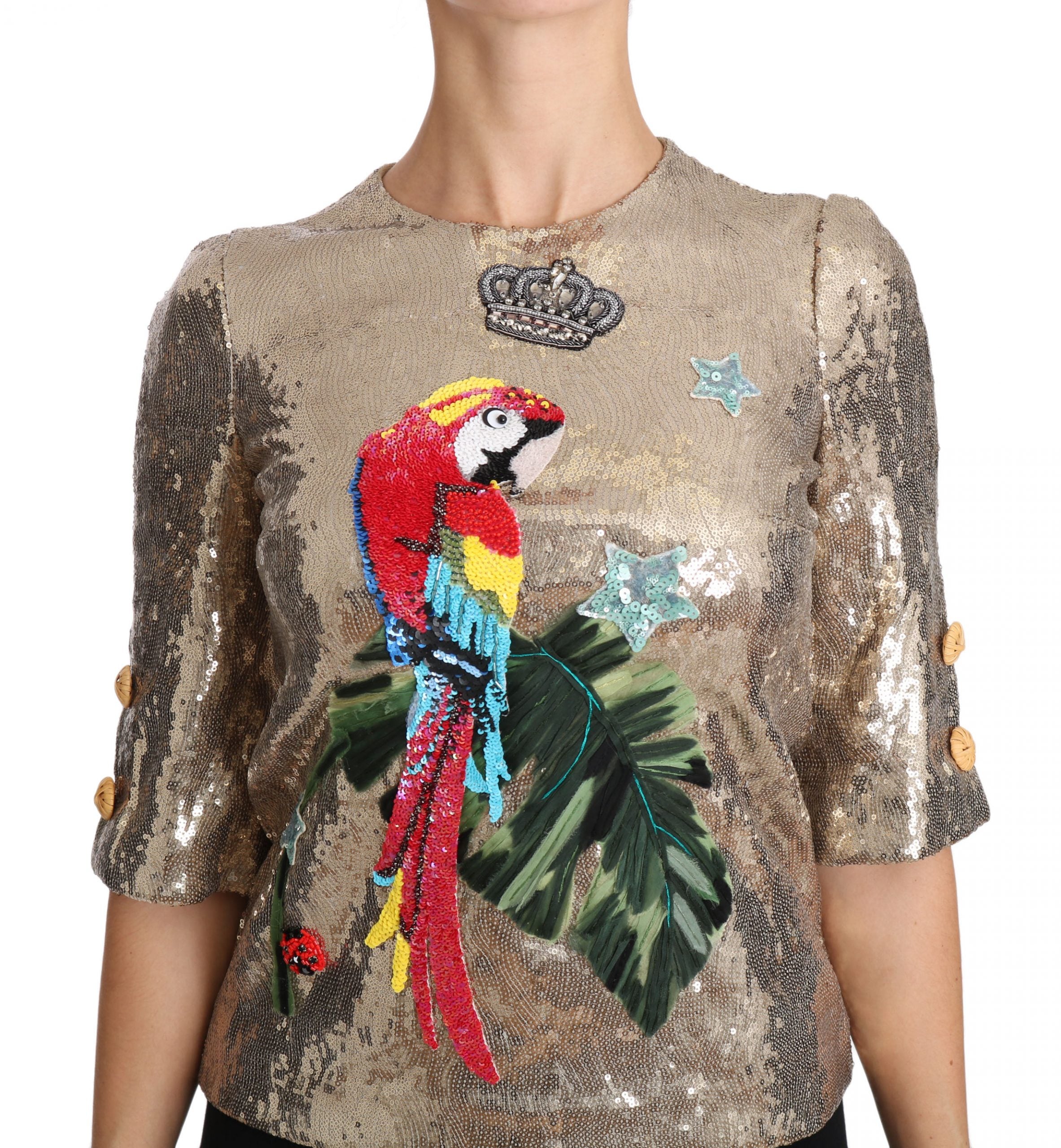Goudkleurige blouse met pailletten en papegaaikristal